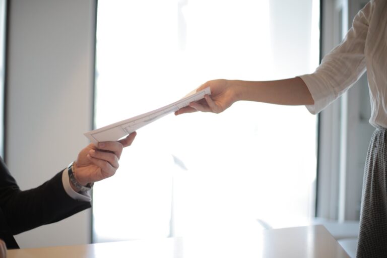 job applicant passing her documents